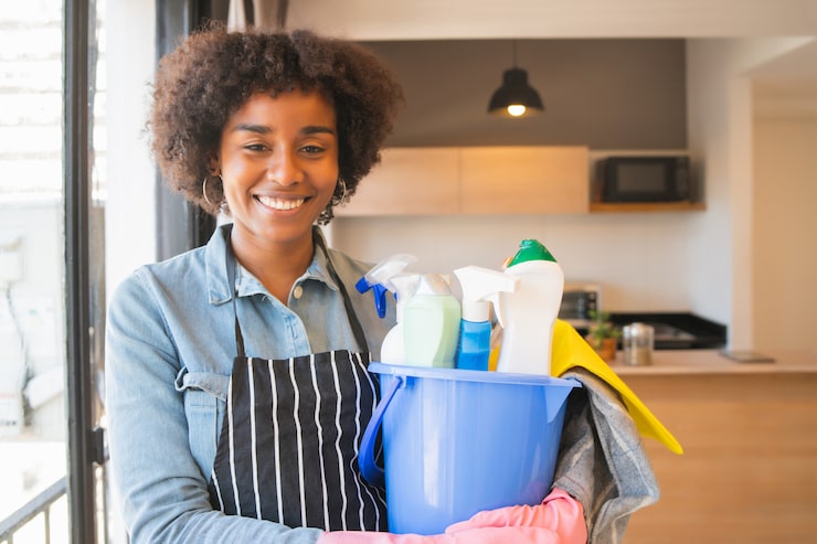 afro woman holding bucket with cleaning items 58466 11246
