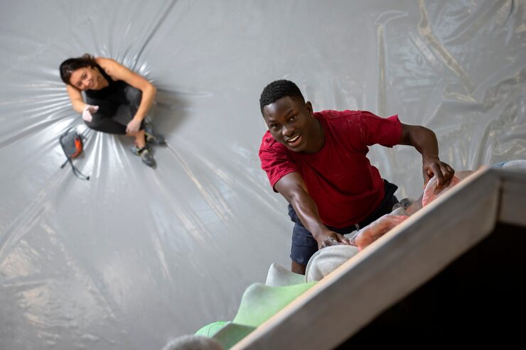 full shot man climbing wall 23 2150510790